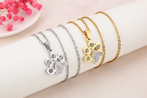 Detail of cute cat paw pendants in gold and silver finish with sparkling zircons