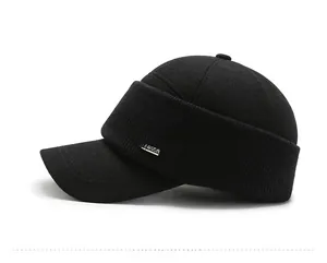 Detail view of winter black fleece cap for elderly men with metal Vashion side plaque