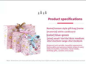 Three sizes of pink unicorn paper gift bags with colorful ribbon handles for kids