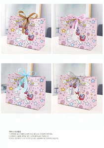 Detailed view of unicorn gift bags with colorful silk bows in gold, pink, blue, and silver