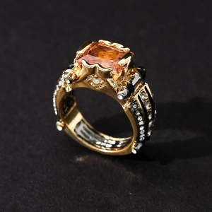 Luxury two-tone ring with orange rectangle gemstone and black and white crystals