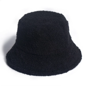 Close-up of the plush teddy fleece texture on a black winter bucket hat for women