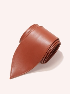 Detailed macro view of brown leather waist belt with fine stitching and pointed tip end