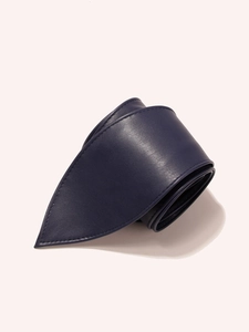 Detail of dark blue leather waist belt showing soft texture and stitching