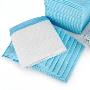 Detail of disposable pet training pads showing blue PE backing and diamond quilted surface
