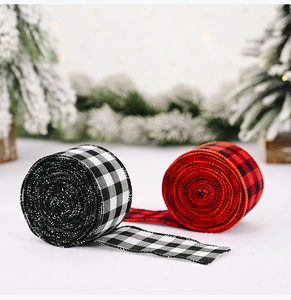 Detail of buffalo check Christmas ribbons in red, black, and white on a festive tree