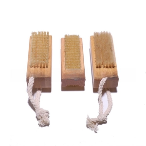 Three-piece bamboo nail brushes with natural bristles and hanging ropes in a top view