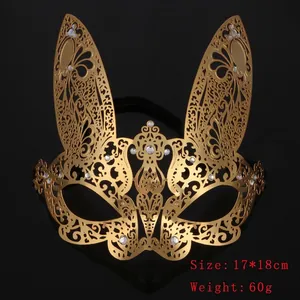 Detailed macro view of golden rabbit filigree metal mask with sparkling rhinestones