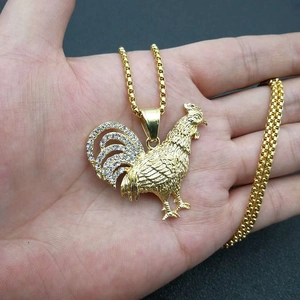Iced out gold rooster pendant necklace with cubic zirconia on a box chain for men