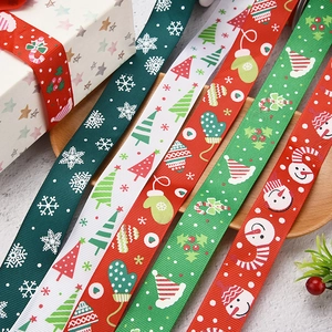Detail of Christmas gold-foil ribbons with snowflakes, trees and gloves patterns
