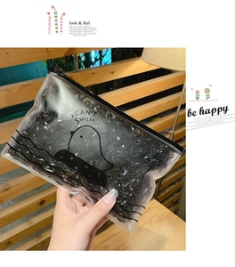 Detail of transparent PVC pouch with black elastic hair bands and cute cartoon duck design