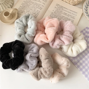 Detailed view of plush faux fur hair scrunchies in 7 pastel colors for autumn and winter