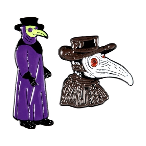 Detailed macro view of two plague doctor enamel pins in purple and brown zinc alloy finish