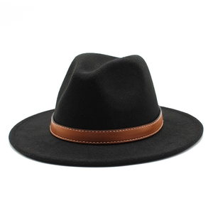 Close-up of black fedora hat with brown leather band and white contrast stitching