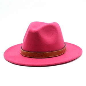 Detail view of hot pink wool fedora with brown leather band and contrast stitching