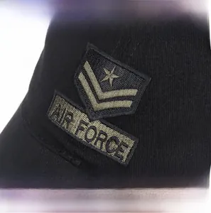 Macro detail of military-style Air Force embroidery on a black cotton baseball cap