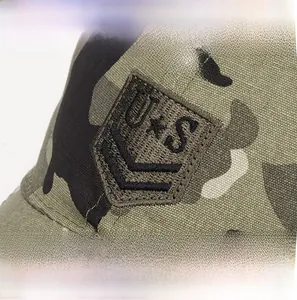 Macro view of camouflage cotton fabric and high-density shield embroidery on baseball cap