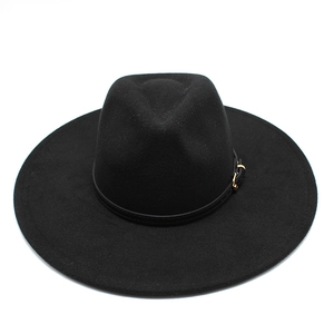Detail of classic black wool felt wide brim fedora with leather band and gold buckle