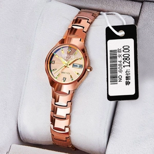 Close-up of ORUSS rose gold watch dial with date display on a gray plush pillow