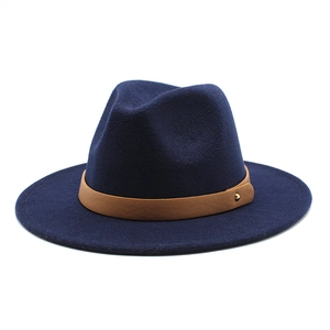 Close-up of navy wool fedora with brown faux leather band and gold stud accent