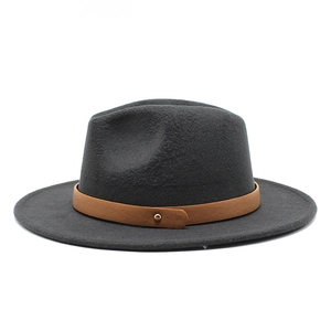 Detail of dark grey wool fedora hat featuring brown leather band and gold buckle accent