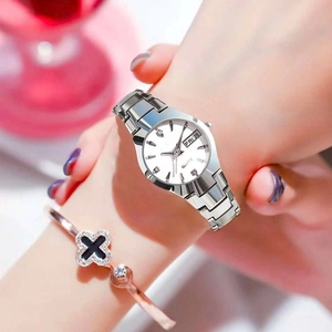 Detail of silver quartz watch with diamond markers, date window and clover bracelet
