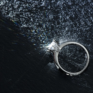Macro view of classic six-prong solitaire ring showing the S925 hallmark on silver band