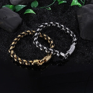 Men's woven black leather bracelet with interlocking steel rings on natural stone surface