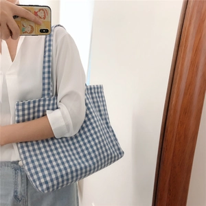 Detailed close-up of blue and white checkered cotton canvas tote bag showing grid pattern