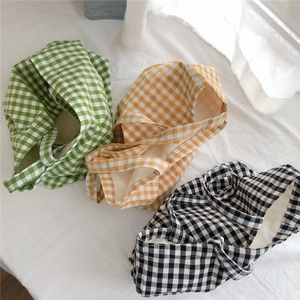 Detailed close-up of Gingham plaid cotton tote bags in green, yellow, and black colors