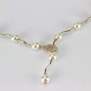 Elegant gold wave chain belt for women with white pearls and a sparkling rhinestone leaf charm