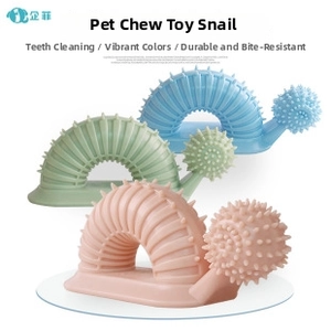 Close-up of snail-shaped dog chew toys with cleaning bumps in pink, green and blue