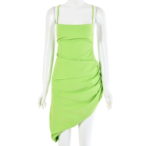 Detail view of neon green mini dress with spaghetti straps and asymmetrical pleated hemline
