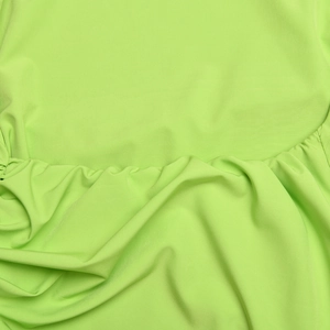 Detail shot of turquoise fabric showing smooth texture and elegant drape folds