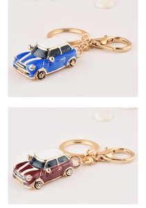 Detail of blue and red metal car keychains with golden rings in a stylish display