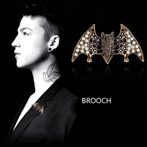 Gothic bat brooch with black and white rhinestones on gold base shown on male model