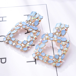 Detail of geometric square earrings with light blue crystals and AB rhinestones
