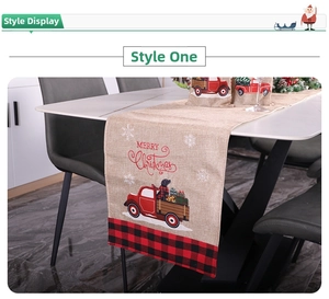 Detail of Christmas burlap table runner featuring red truck design on white dining table