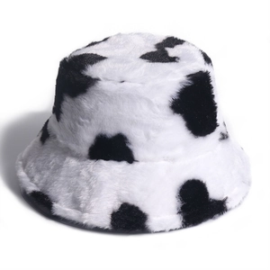 Furry cow print bucket hat in black and white plush faux fur for winter warmth