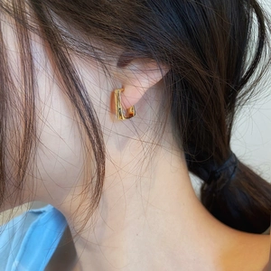 Minimalist gold geometric rectangular hoop earrings for women shown on a model