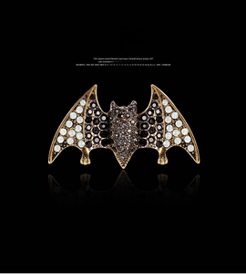 Detailed close-up of a vintage bat brooch with black crystals and colorful rhinestones