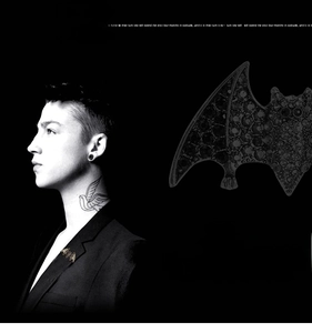 Macro detail of retro rhinestone bat brooch with dark crystals on a suit lapel