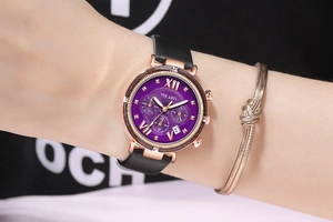 Detailed macro view of purple sunray dial with rose gold case and black leather strap