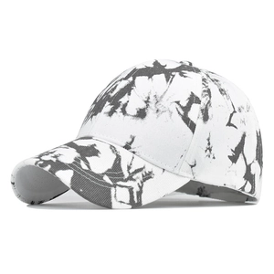 Detail view of cotton baseball cap with black and white tie-dye ink pattern and curved brim