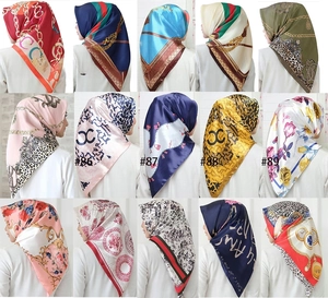 Collage of fifteen 90x90cm satin square scarves with floral and chain print patterns