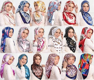 Detail showing 18 varied printed satin hijabs featuring floral and geometric patterns