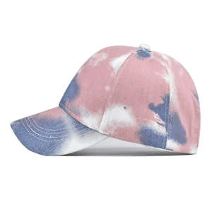 Detailed side view of tie-dye cotton baseball cap with pink and blue gradient pattern