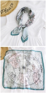 Detail of vintage map and compass print on premium silk scarf with green border trim