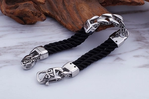 Macro view of 316L stainless steel clasp with vintage engraving and black braided rope