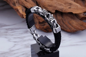 Detailed view of men's geometric titanium steel totem bracelet with black nylon cord